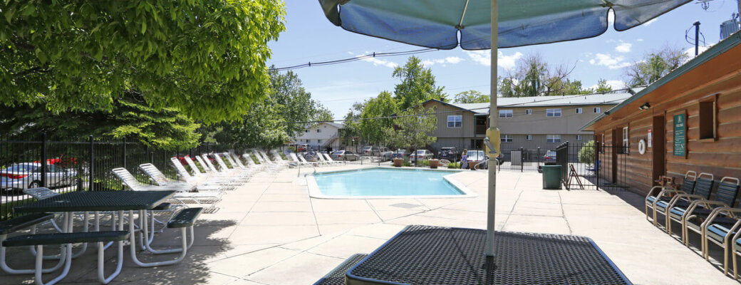 Another pool view - tables, pool, deck chairs at our Boulder apartments.