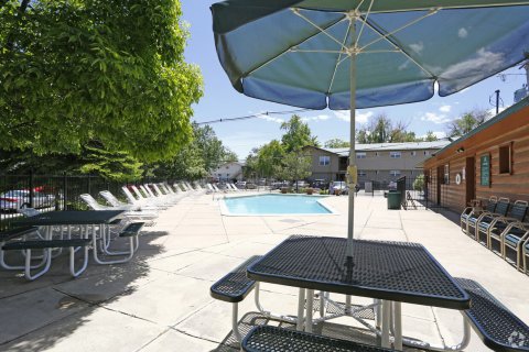 Another pool view - tables, pool, deck chairs at our Boulder apartments.