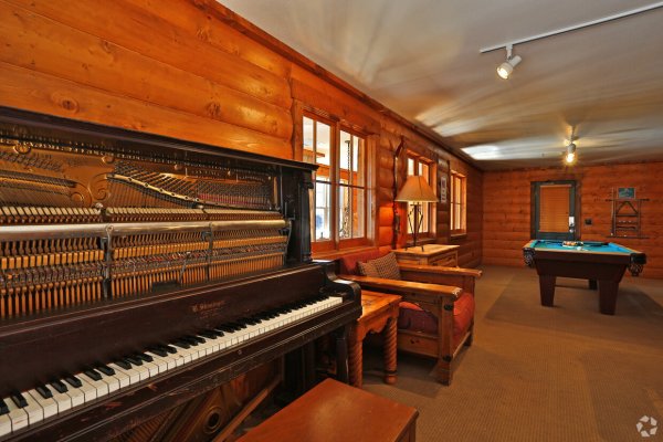 Player piano and pool table in the common area at our Boulder apartments.