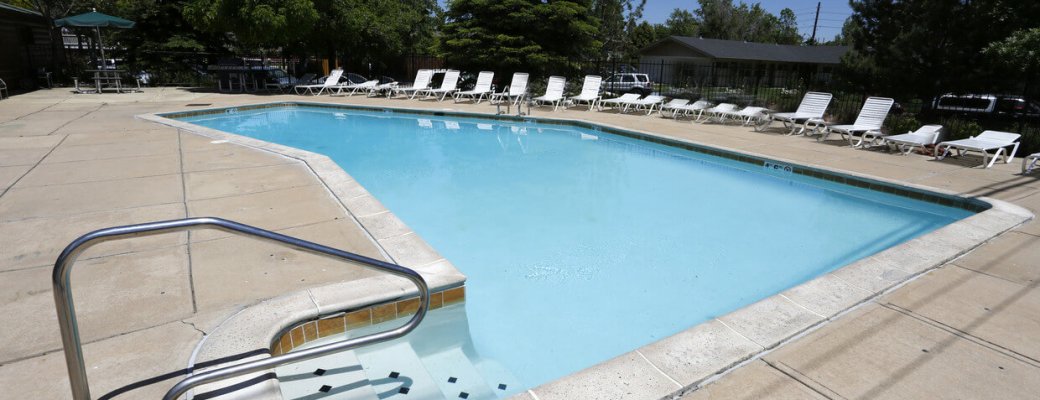 Large pool with deck chairs