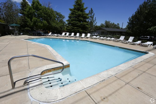 Large pool with deck chairs at our Boulder apts.