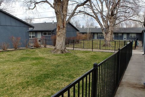 Sidewalk with fence around our Boulder CO apartment complex.